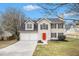 Charming two-story home with a manicured lawn, two-car garage, and a vibrant red front door at 2549 Greenville Way, Decatur, GA 30034