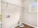 Practical laundry room with shelving, natural light, and laminate flooring at 2549 Greenville Way, Decatur, GA 30034
