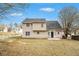 Two-story house showcasing a well-maintained backyard, a dark shingled roof and a small back patio at 2549 Greenville Way, Decatur, GA 30034