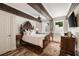 Beautiful bedroom featuring wood-beamed ceiling, paneled walls, and plank floors at 5575 Glen Errol Rd, Sandy Springs, GA 30327