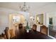 Elegant dining room with dark wood table, chandelier, and view to kitchen at 5575 Glen Errol Rd, Sandy Springs, GA 30327