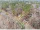 Aerial view of home with fenced pool and wooded surrounding at 620 Bell Se Rd, Conyers, GA 30094