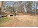 Backyard featuring a grill, a trampoline, a wooden deck, with a covered pool in the distance at 620 Bell Se Rd, Conyers, GA 30094