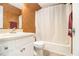 This bathroom includes a shower with curtain, a white vanity sink, a mirror and a toilet at 620 Bell Se Rd, Conyers, GA 30094