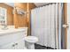 Bathroom with white vanity, toilet, shower with patterned curtain, and wall storage at 620 Bell Se Rd, Conyers, GA 30094