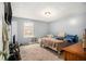 This bedroom features neutral paint, a window, carpeted floors, and a ceiling fan at 620 Bell Se Rd, Conyers, GA 30094