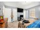 Bedroom with neutral paint, carpeted floors, a window, closet, and ceiling fan at 620 Bell Se Rd, Conyers, GA 30094