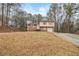 Daytime view of a charming two-story brick home with an attached single car garage at 620 Bell Se Rd, Conyers, GA 30094