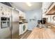 Updated kitchen with white cabinets, butcher block countertops, and stainless steel appliances at 620 Bell Se Rd, Conyers, GA 30094