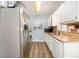 Kitchen with white cabinets, butcher block countertops, and stainless steel appliances at 620 Bell Se Rd, Conyers, GA 30094