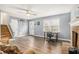 The living room has vinyl plank flooring, a brick fireplace, a ceiling fan, and stairs to the upper level at 620 Bell Se Rd, Conyers, GA 30094