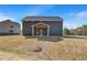 Backyard view of the home with a covered patio and a grass lawn at 132 Felicity Pike, Locust Grove, GA 30248