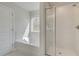 This bathroom shows a tub next to a window, and a shower with glass doors at 132 Felicity Pike, Locust Grove, GA 30248