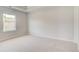 Neutral bedroom features a window and plush carpeting at 132 Felicity Pike, Locust Grove, GA 30248