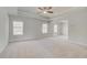 Spacious bedroom with tray ceiling, carpet, and three windows at 132 Felicity Pike, Locust Grove, GA 30248