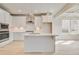 Bright kitchen features island, modern appliances, and white cabinets at 132 Felicity Pike, Locust Grove, GA 30248