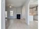 Bright living room with fireplace, hardwood floors and entrance to kitchen at 132 Felicity Pike, Locust Grove, GA 30248