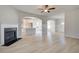 Open living room flowing into the kitchen, featuring wood floors and a cozy fireplace at 132 Felicity Pike, Locust Grove, GA 30248