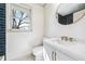 Bright bathroom with a white vanity, gold fixtures, and a window offering natural light at 1771 Mount Vernon Rd, Atlanta, GA 30338