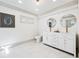 Modern bathroom with double sink vanity, tile floor, and painted brick accent wall at 1771 Mount Vernon Rd, Atlanta, GA 30338