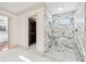 Walk in shower with marble tile and gold fixtures next to the walk in closet at 1771 Mount Vernon Rd, Atlanta, GA 30338
