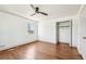 Bedroom with sleek ceiling fan and wood floors offering closet access for storage at 1771 Mount Vernon Rd, Atlanta, GA 30338