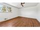 Large bedroom with wood floors, a ceiling fan, and ample natural light from the window at 1771 Mount Vernon Rd, Atlanta, GA 30338