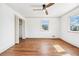 Spacious bedroom with hardwood floors, white walls, closet and a ceiling fan at 1771 Mount Vernon Rd, Atlanta, GA 30338