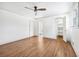 Bright bedroom with hardwood floors, closet, ceiling fan, and a view of the backyard at 1771 Mount Vernon Rd, Atlanta, GA 30338