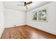 Bedroom featuring hardwood floors, a ceiling fan, and ample natural light from the window at 1771 Mount Vernon Rd, Atlanta, GA 30338