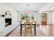 Beautiful dining room featuring a white brick fireplace, natural light, and stylish decor at 1771 Mount Vernon Rd, Atlanta, GA 30338