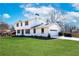 Well-manicured lawn and charming white brick home with an attached garage and inviting curb appeal at 1771 Mount Vernon Rd, Atlanta, GA 30338