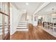 Bright foyer with hardwood floors, staircase, and open view into the dining and kitchen area at 1771 Mount Vernon Rd, Atlanta, GA 30338