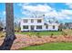 Charming two-story home with white brick, dark trim, and a beautifully landscaped front yard at 1771 Mount Vernon Rd, Atlanta, GA 30338
