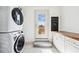 This mud/laundry room features a stacked washer/dryer and custom built-in cabinets at 1771 Mount Vernon Rd, Atlanta, GA 30338