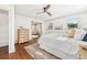 Light and airy main bedroom with a ceiling fan, hardwood floors, and bright windows at 1771 Mount Vernon Rd, Atlanta, GA 30338