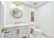 Stylish powder room with a modern vanity, gold fixtures, and a round decorative mirror at 1771 Mount Vernon Rd, Atlanta, GA 30338