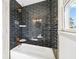 Updated shower featuring dark tile, a rainfall showerhead, and built-in shelving at 1771 Mount Vernon Rd, Atlanta, GA 30338