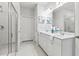 Bright bathroom features a double vanity with sleek fixtures and a glass-enclosed shower at 3903 Shelleydale Dr, Powder Springs, GA 30127