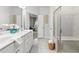 Elegant bathroom features a double vanity, a glass shower, and neutral tile at 3903 Shelleydale Dr, Powder Springs, GA 30127