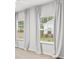 Bright bedroom features large windows dressed with long curtains and a view of the outdoors at 3903 Shelleydale Dr, Powder Springs, GA 30127