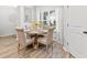 Bright dining area features a round wood table and four upholstered chairs with natural light at 3903 Shelleydale Dr, Powder Springs, GA 30127