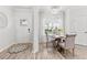 Inviting dining area boasts natural light, a round table, and a charming rug by the front door at 3903 Shelleydale Dr, Powder Springs, GA 30127