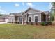 Lovely single-story home with a well-kept lawn, showcasing a welcoming facade and attached garage at 3903 Shelleydale Dr, Powder Springs, GA 30127