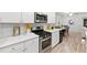 Beautiful kitchen features stainless steel appliances, white subway tile backsplash, and gas range at 3903 Shelleydale Dr, Powder Springs, GA 30127