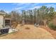 Expansive backyard with a patio, seating areas, mature trees, and lush greenery for outdoor enjoyment at 918 Bridge Mill Ave, Canton, GA 30114