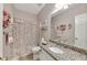 Bright bathroom with granite counters and floral shower curtain at 918 Bridge Mill Ave, Canton, GA 30114