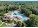 Aerial view of a large community pool area featuring multiple pools, slides, and lounge areas, surrounded by lush landscaping at 918 Bridge Mill Ave, Canton, GA 30114