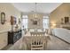Elegant dining room featuring a chandelier, large windows, and tastefully coordinated decor, bathed in natural light at 918 Bridge Mill Ave, Canton, GA 30114