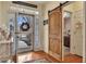 Elegant foyer with hardwood floors, charming decor, and a view through the glass front door to the outside at 918 Bridge Mill Ave, Canton, GA 30114